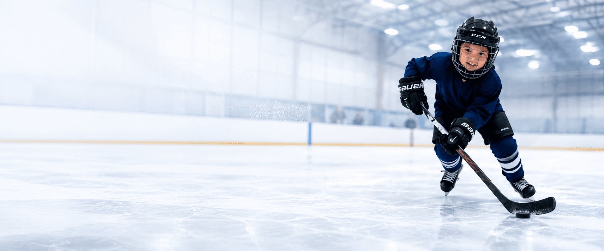 Young hockey player skating with a puck