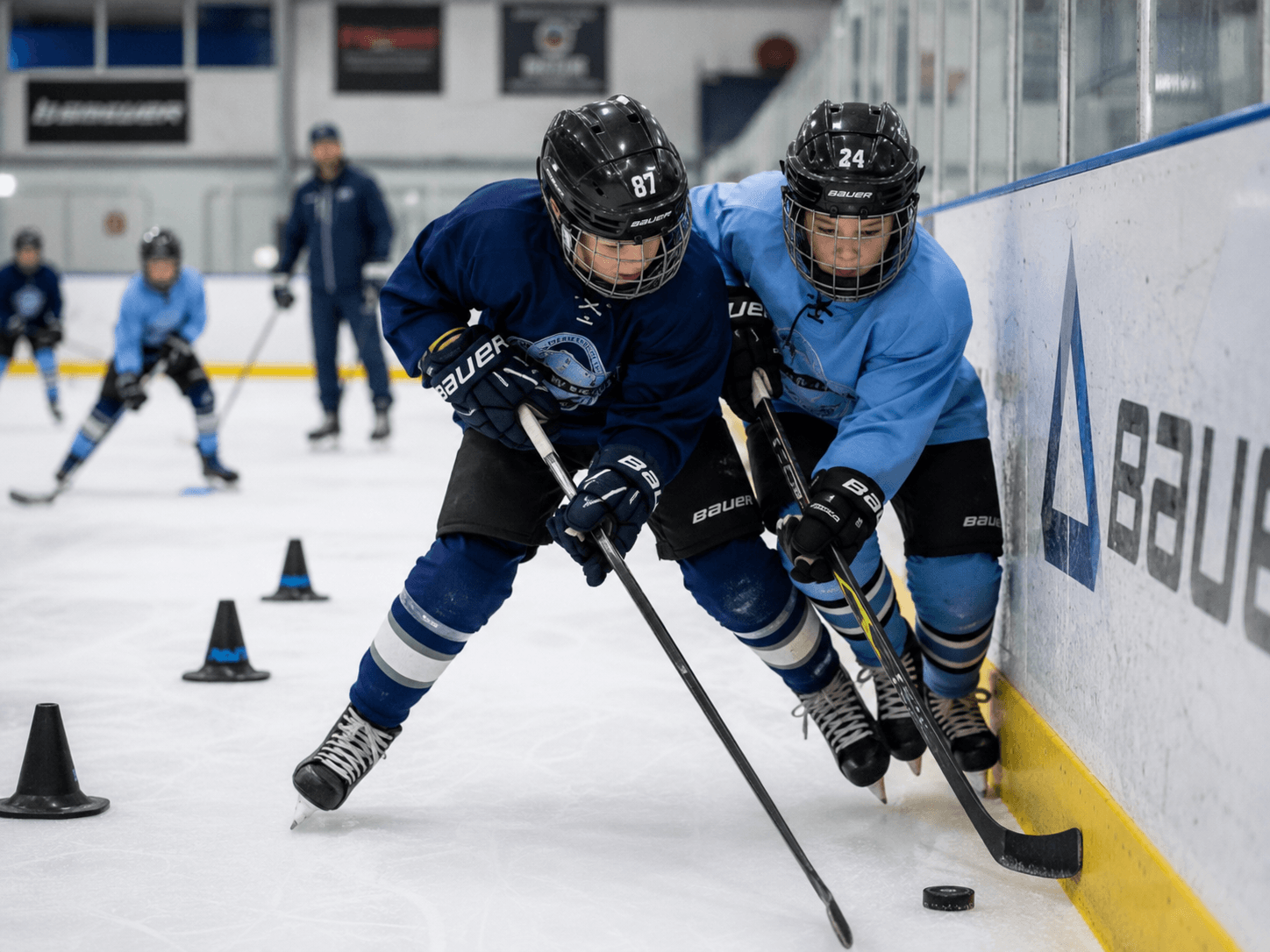 Youth hockey players battling for the puck along the boards